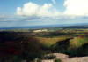 In the middle of Guam there exists a string of mountains. The view from one which has the island television transmission towers is panoramic and includes both east and west shores of Guam. Looking east you see the Japanese Resort and the village of Yona just beyond it and the Pacific Ocean. This area is on a plateau above the shoreline of the Pacific Ocean.